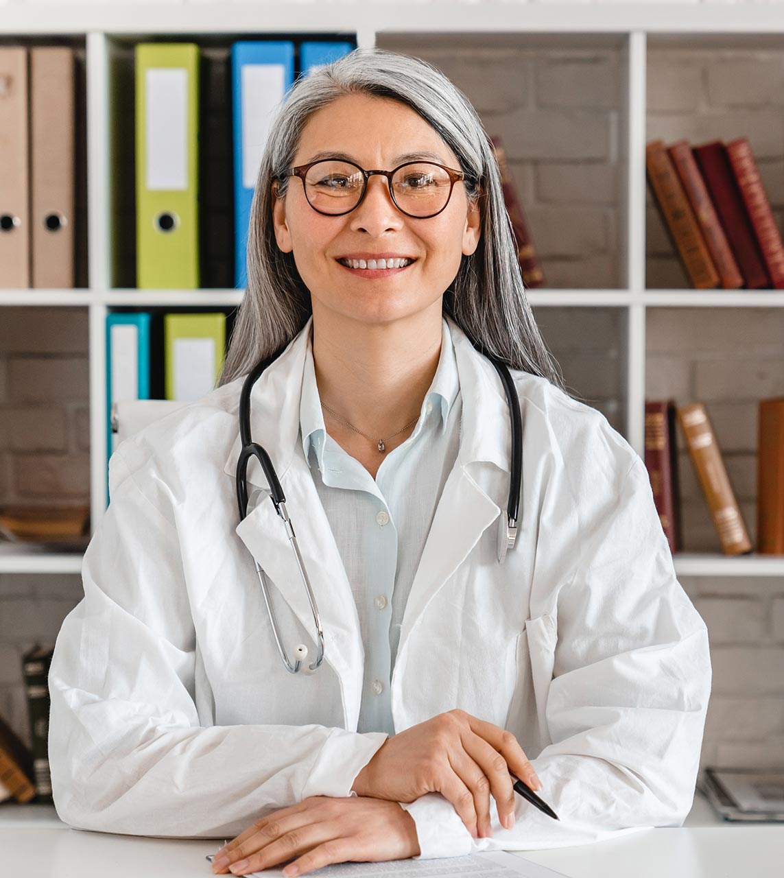 happy-middle-aged-woman-doctor-sitting-at-the-desk-2022-07-06-23-03-01-utc.jpg